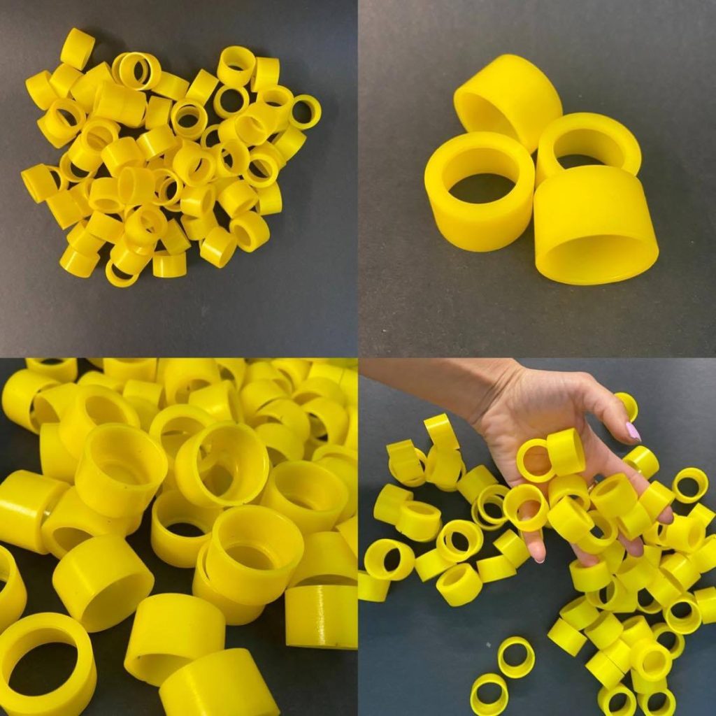 Four shots of yellow plastic rings with a smooth surface, scattered on a black, matte table.