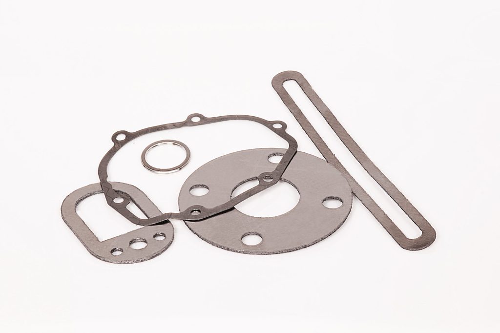 Metal gaskets of various sizes in round and elongated shapes, and a thin ring on a light background.